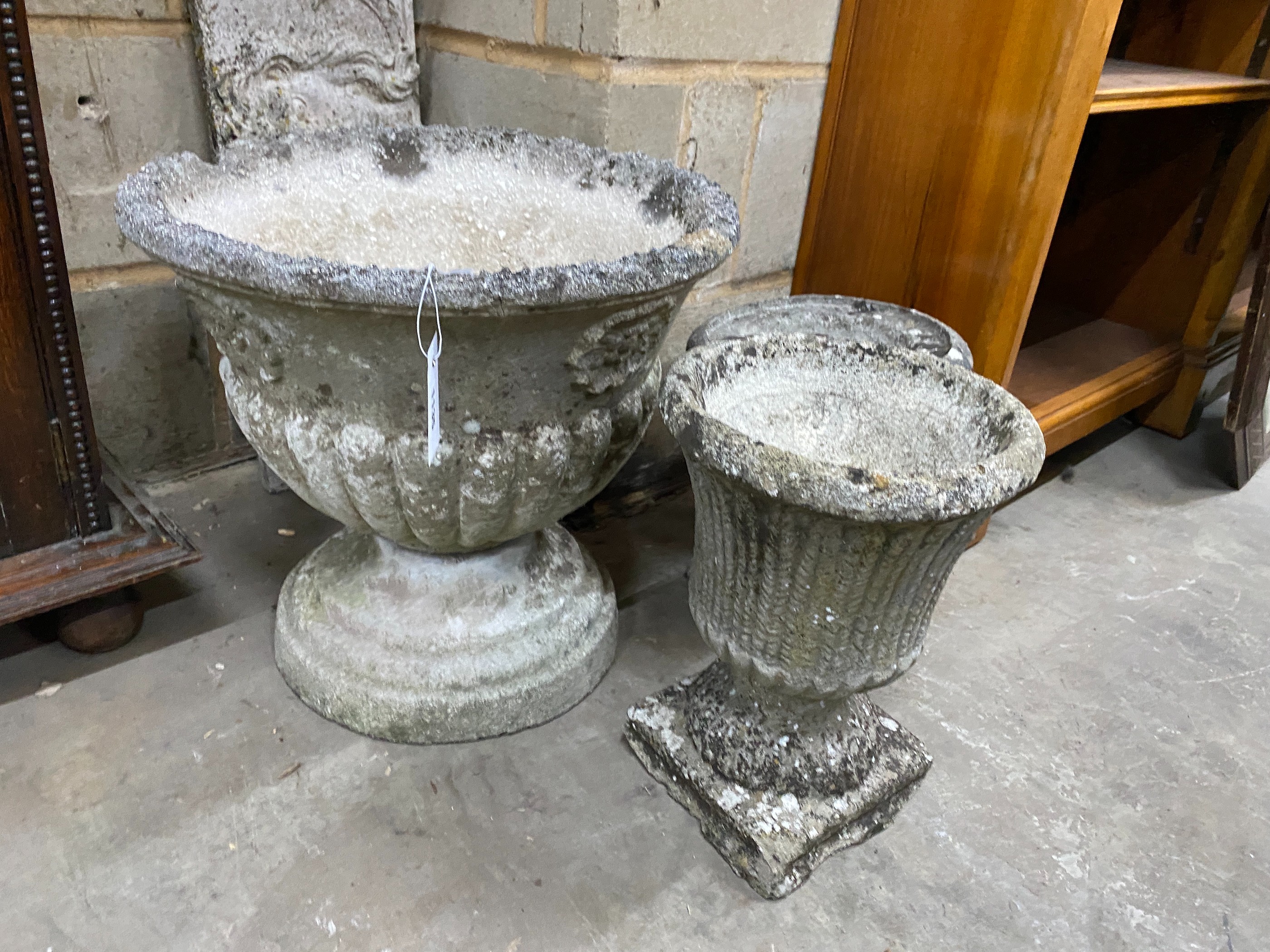 Three circular reconstituted garden urns, largest diameter 44cm, height 40cm
